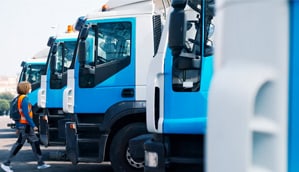 Worker between fleet of blue hydrogen vehicles